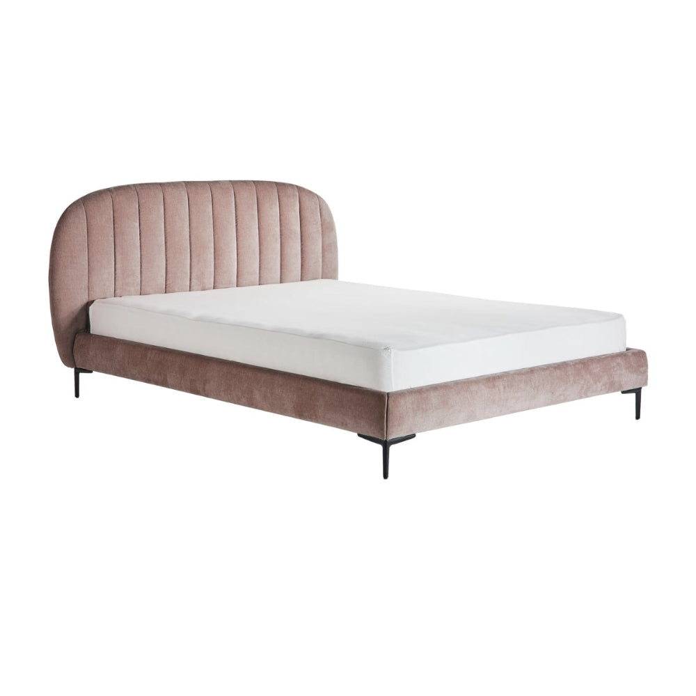Bed with pink upholstered headboard and white mattress on a white background
