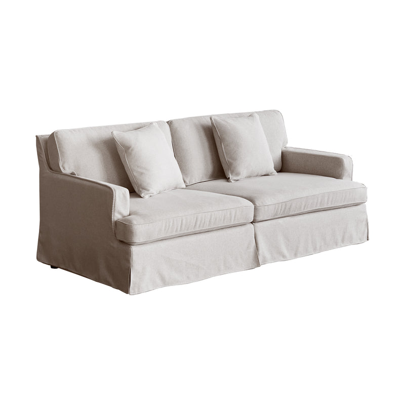 A beige upholstered Souffle sofa with two additional cushions, designed with a simple, modern aesthetic.