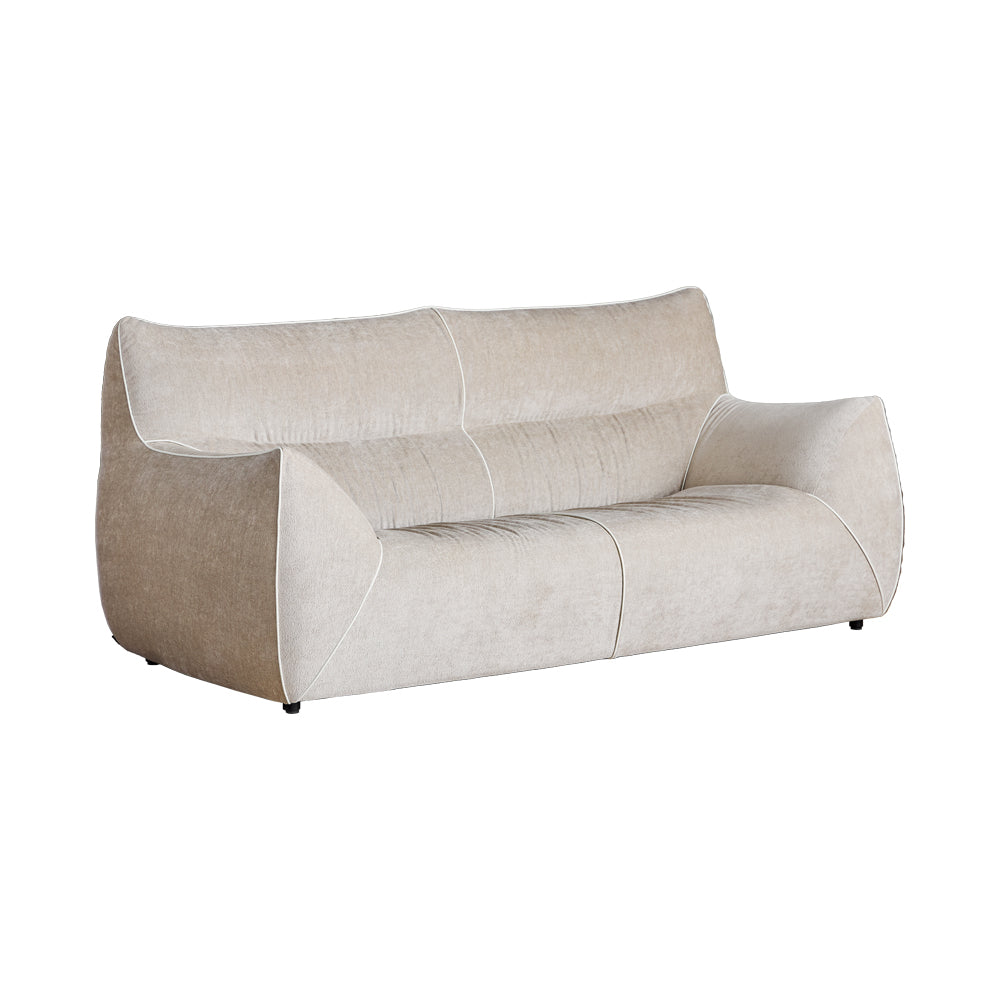 A beige modular sofa with a contemporary design, featuring a low-profile structure with a deep seat and minimal backrest.
