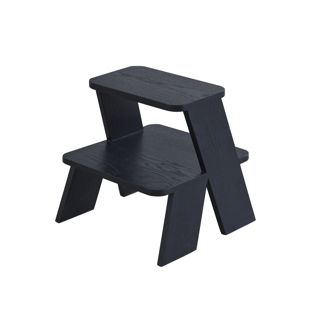 A black two-tier step stool designed by YUUE design studio with a textured finish.