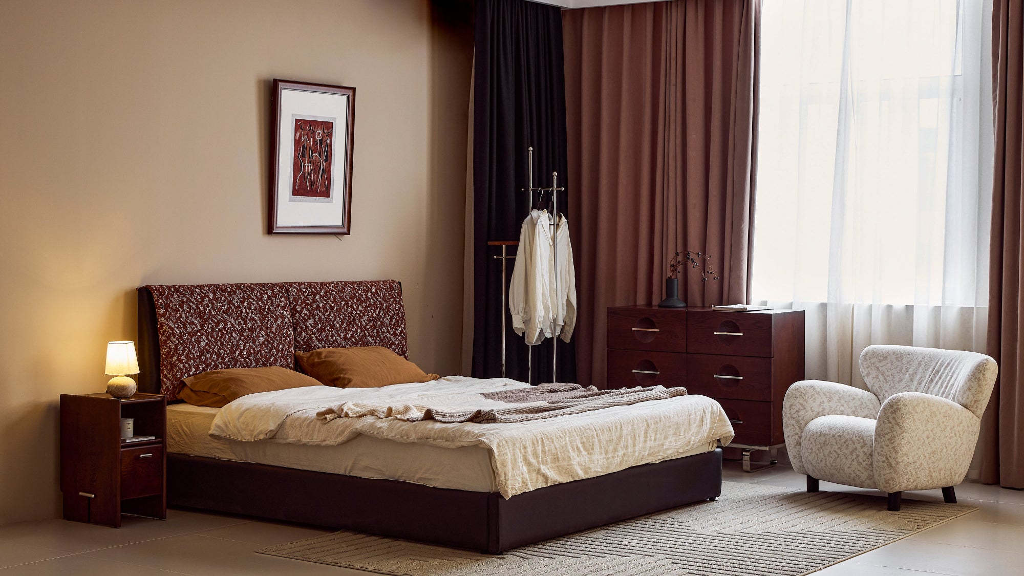 Modern bedroom with a bed, nightstands, and an armchair.
