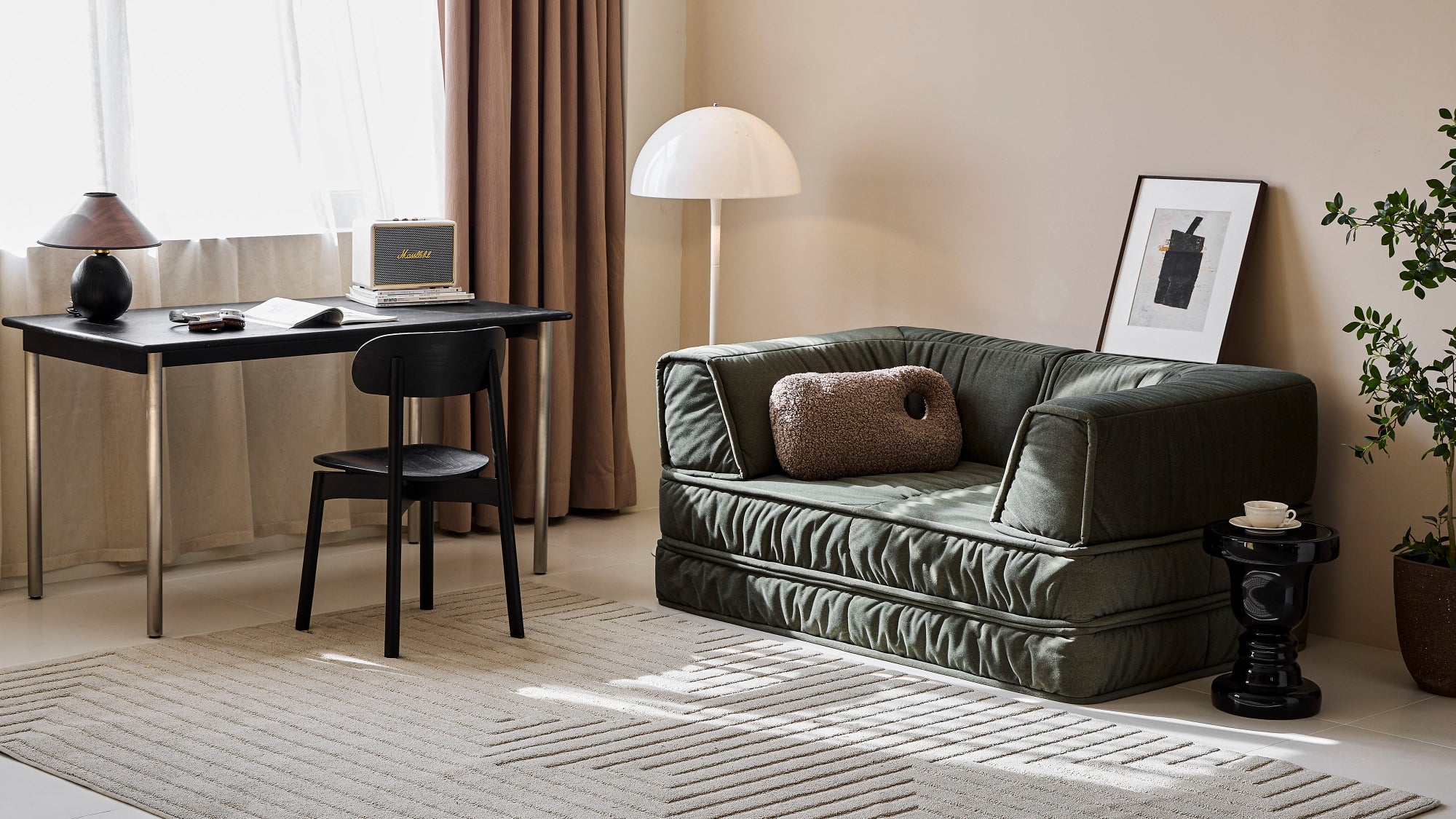 Modern living room with a gray sofa, desk, and decor items.