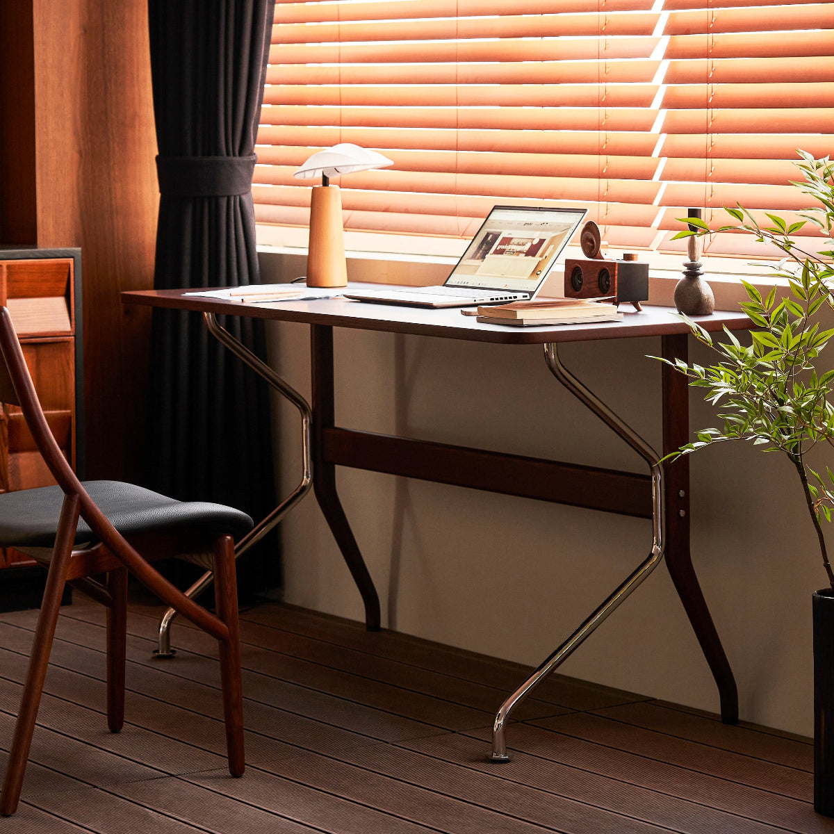 Home office with a desk, laptop, and decor elements.