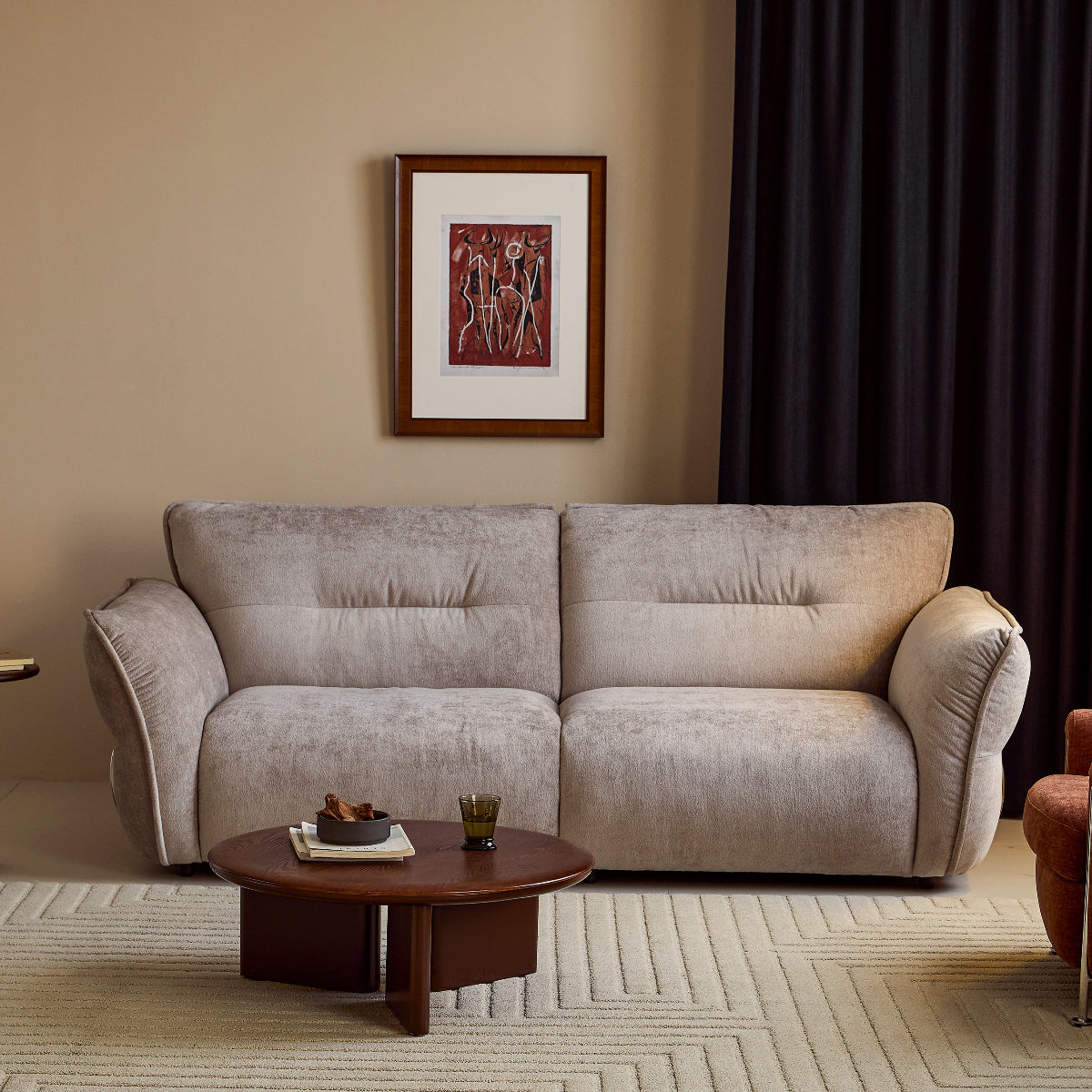 Gray sofa in a living room with a coffee table and framed picture on the wall.
