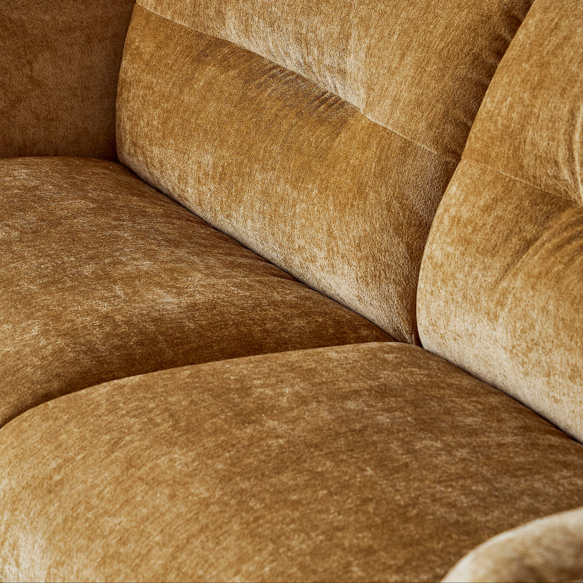 Close-up of a brown sofa with a textured fabric.