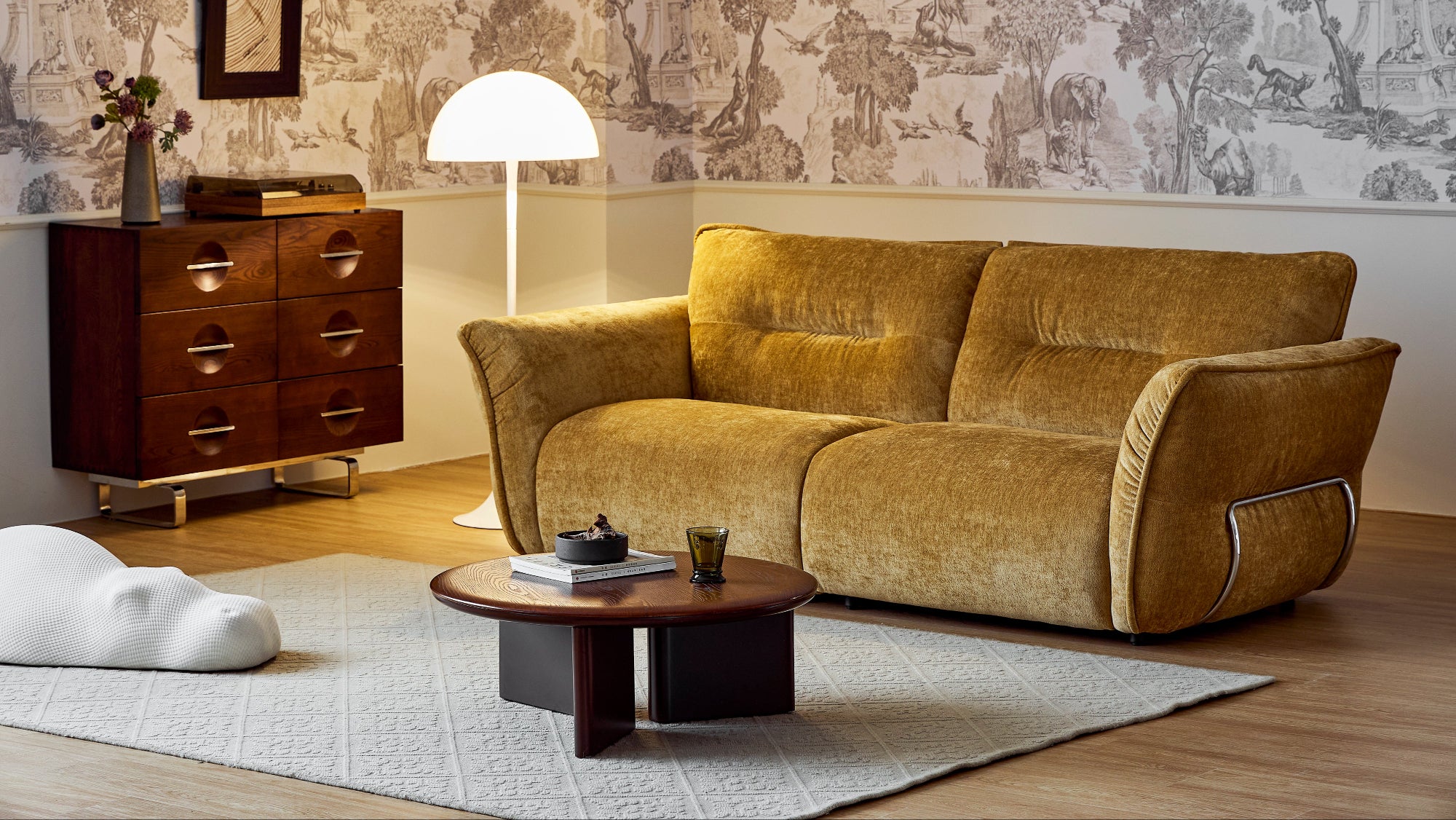 Living room with a brown sofa, coffee table, and decorative items.