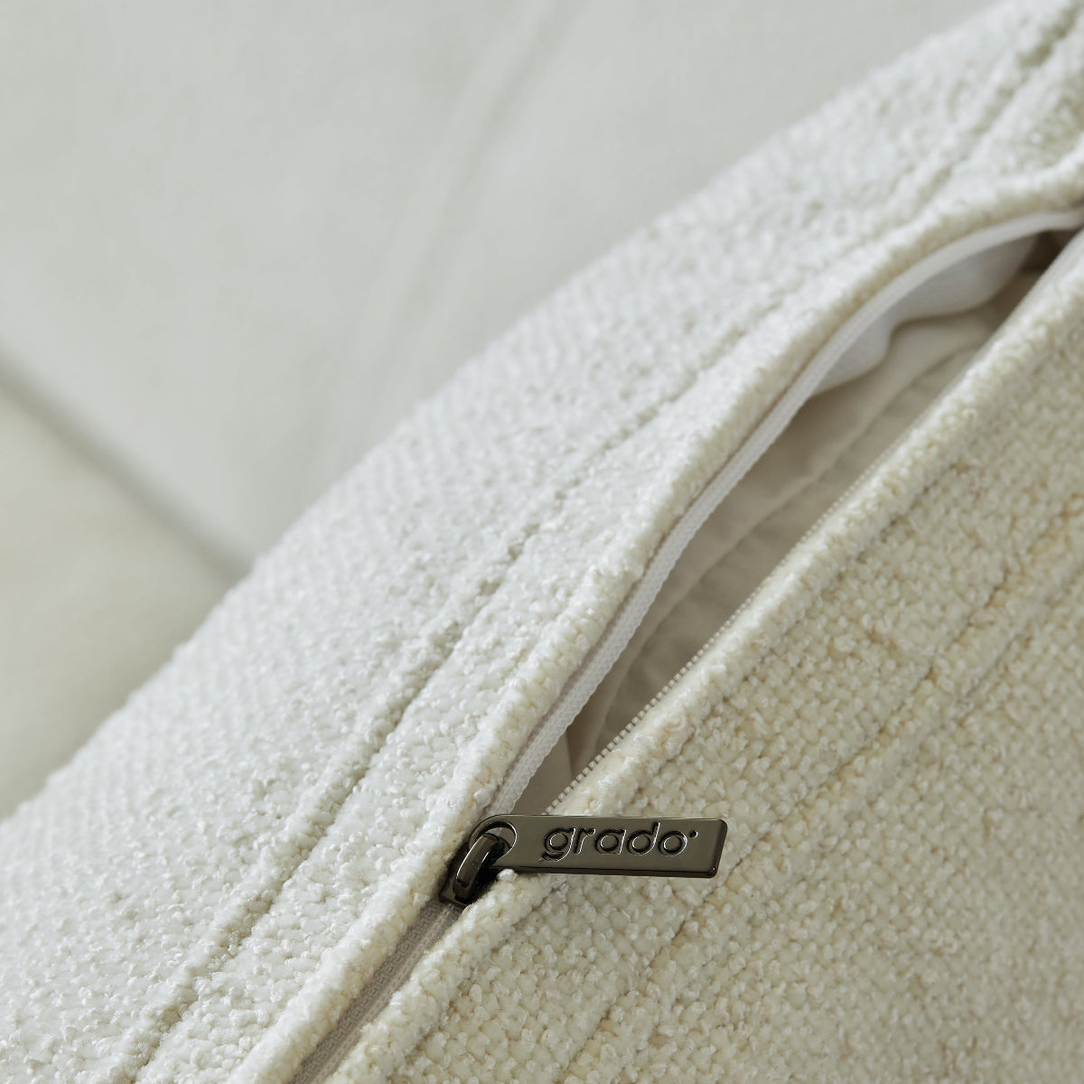 Close-up of a textured fabric surface with a brand logo on a white background