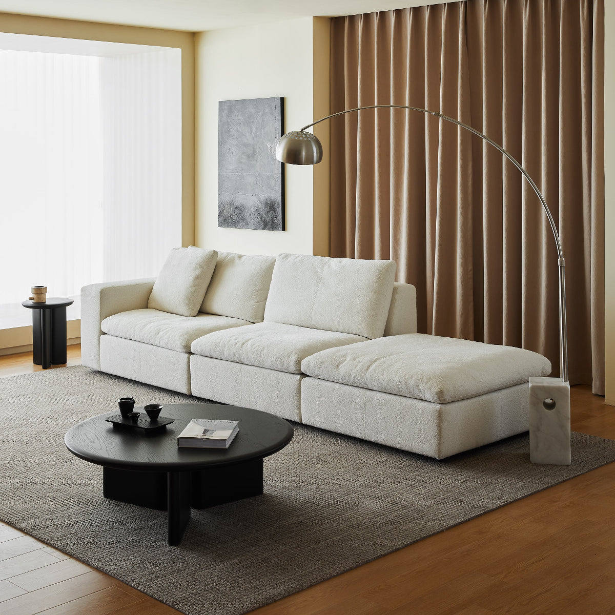 Modern living room with a white sectional sofa, coffee table, and floor lamp.