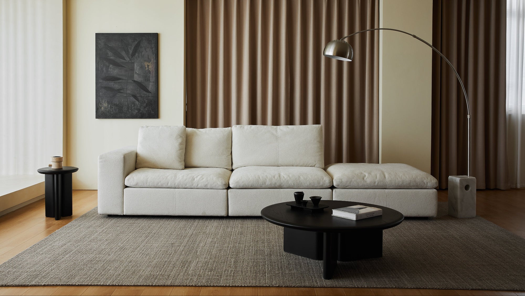 Modern living room with a white sofa, coffee table, and decorative elements.