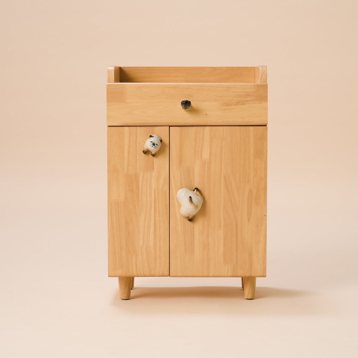 Wooden cabinet with a drawer and two doors on a beige background