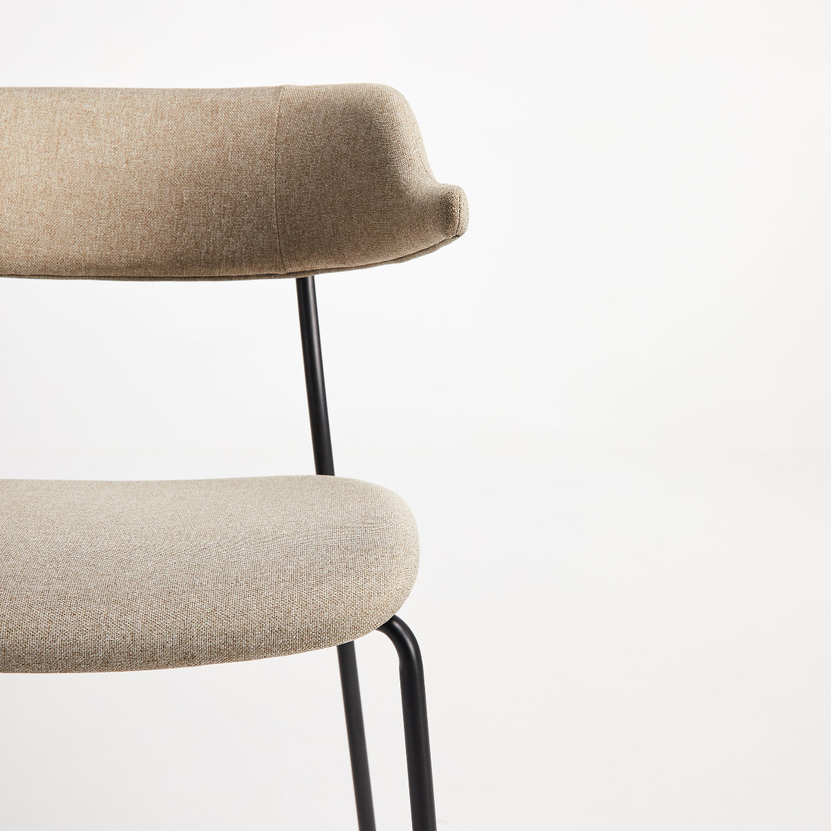 Beige chair with black metal legs on a white background