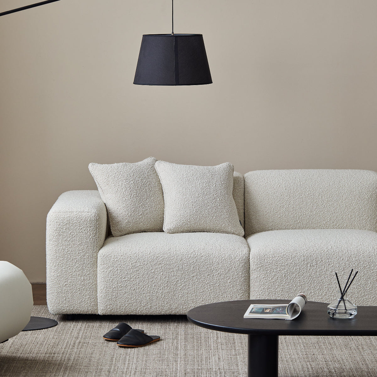 Modern living room with a white sofa, black floor lamp, and coffee table.