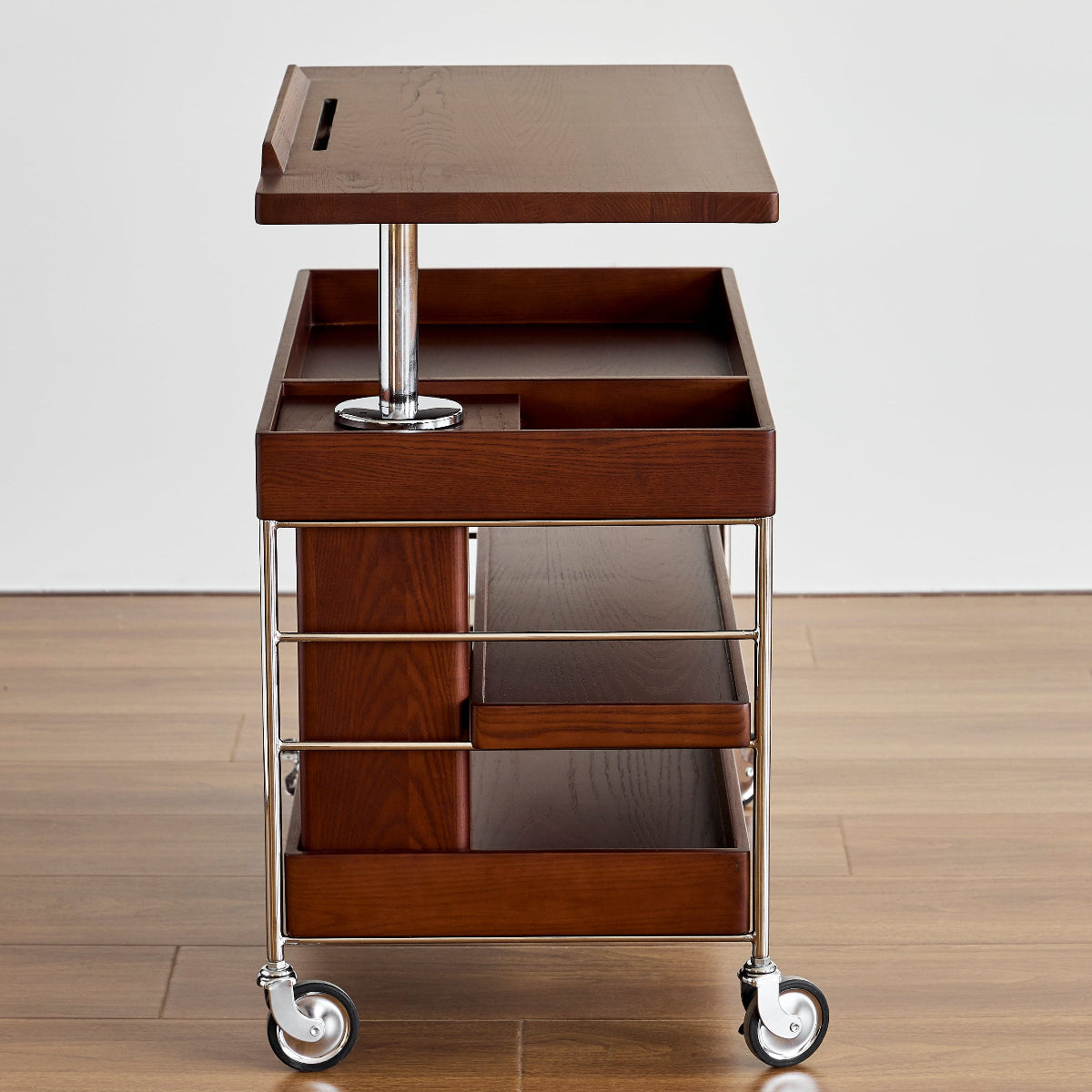 Brown serving cart with wheels on a wooden floor