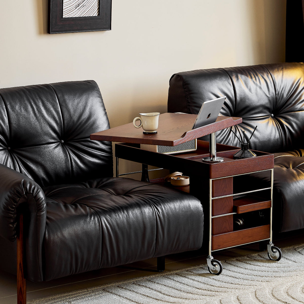 Black leather sofa with a rolling side table in a living room setting.