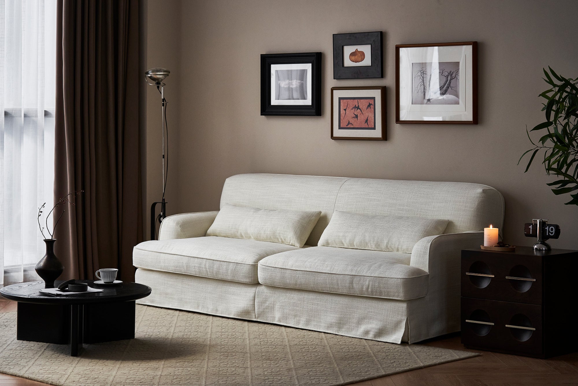 Living room with a beige sofa, coffee table, and wall art.