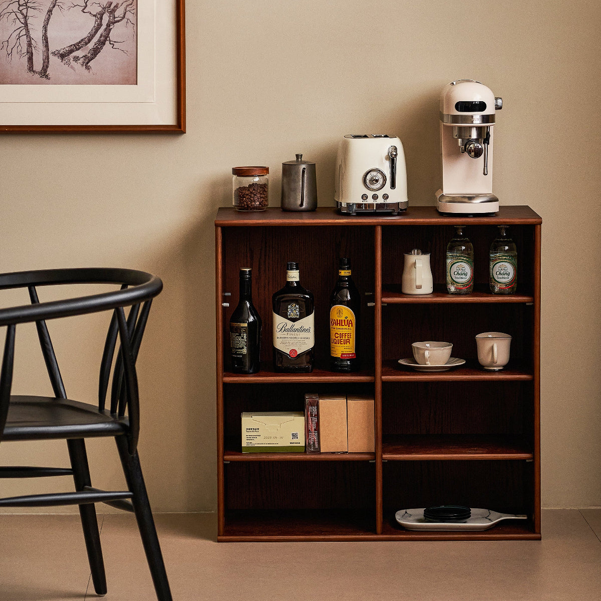 Wooden shelf with kitchen appliances and items against a beige wall.