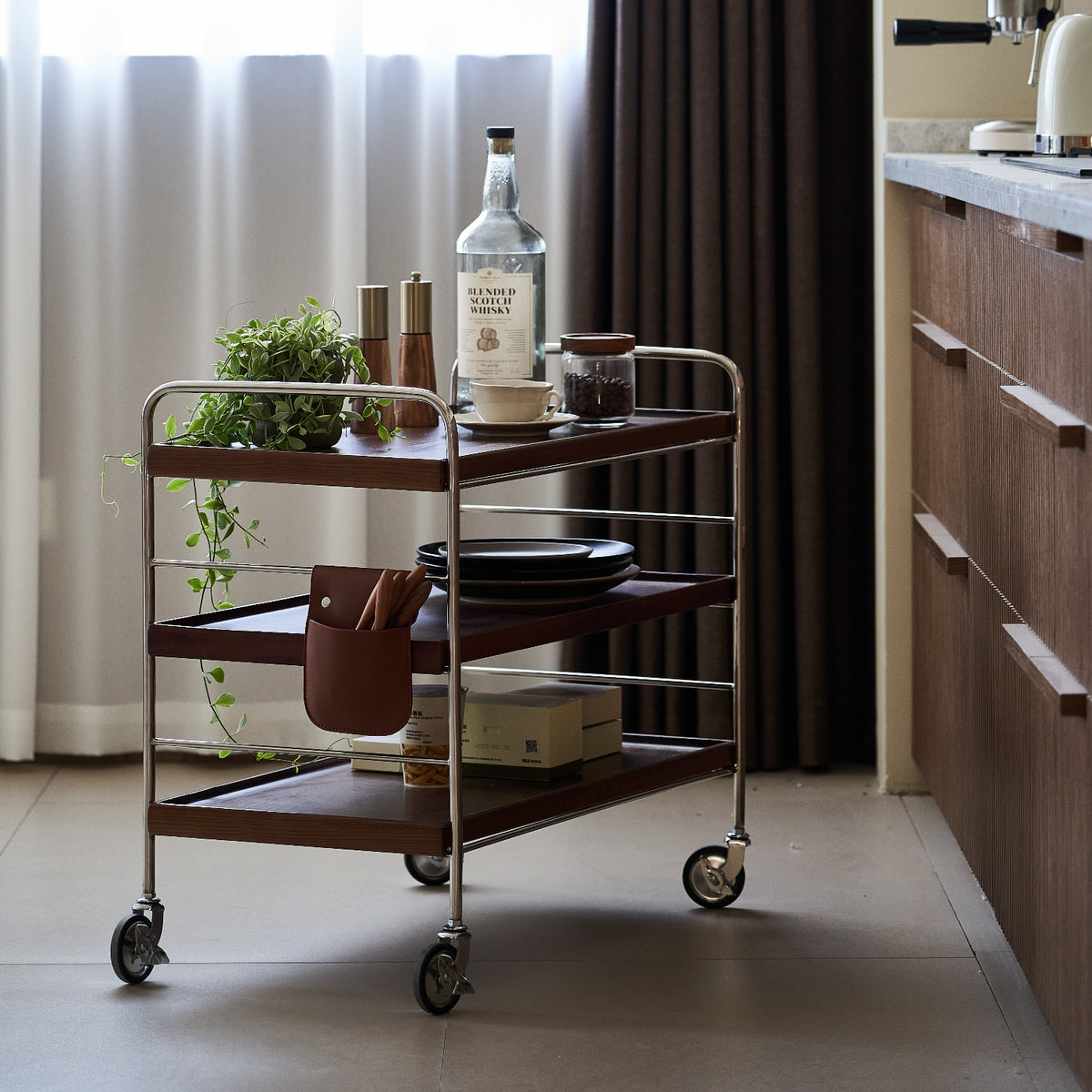 Bar cart with drinks and decor items in a kitchen setting