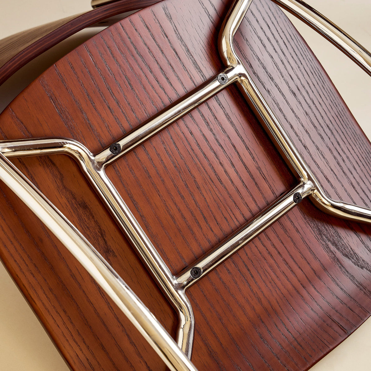 Wooden chair with metal frame on a beige background