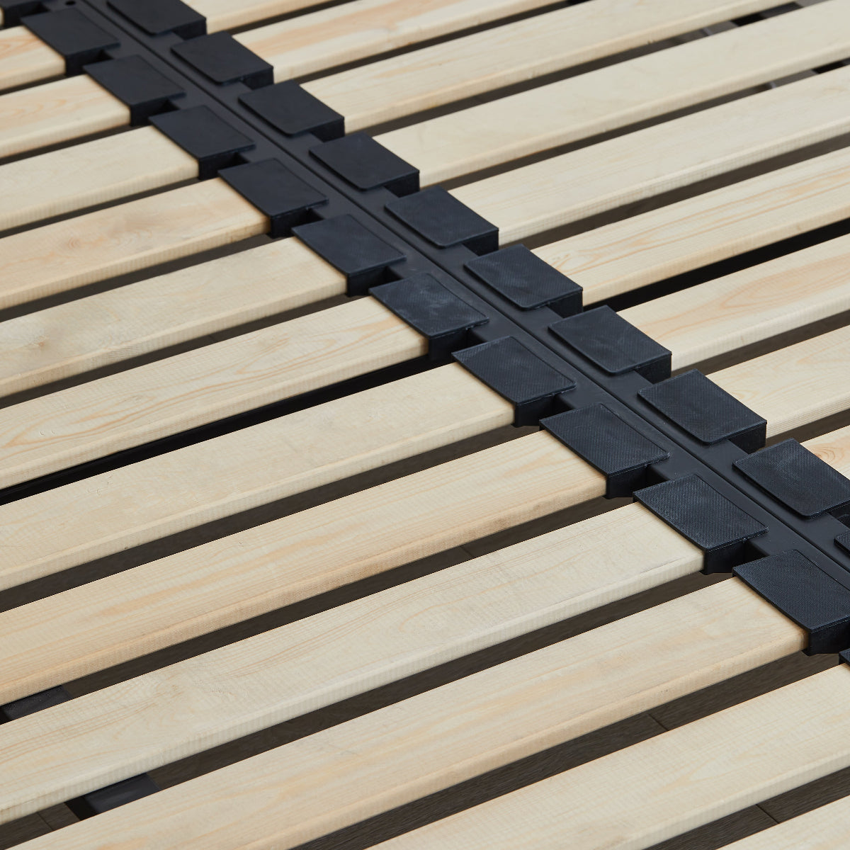 Close-up of a wooden deck with a black interlocking mat