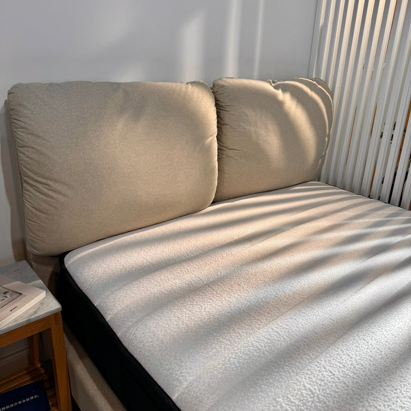 Beige sofa with a striped pattern in a room with sunlight filtering through blinds.