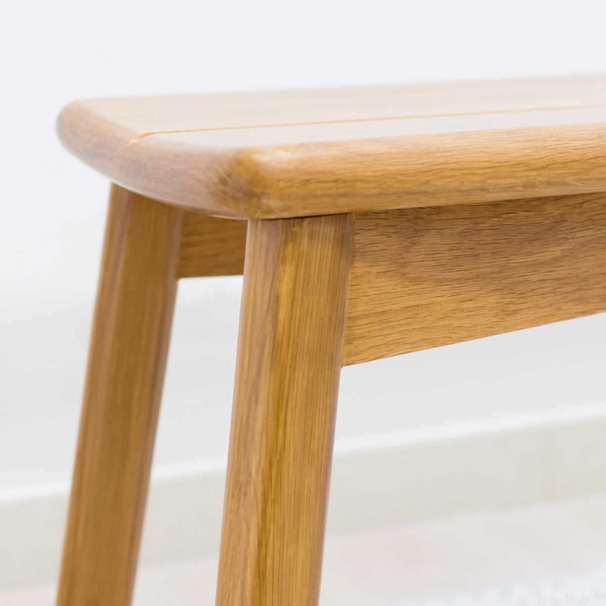 Wooden bench with a light finish on a white background