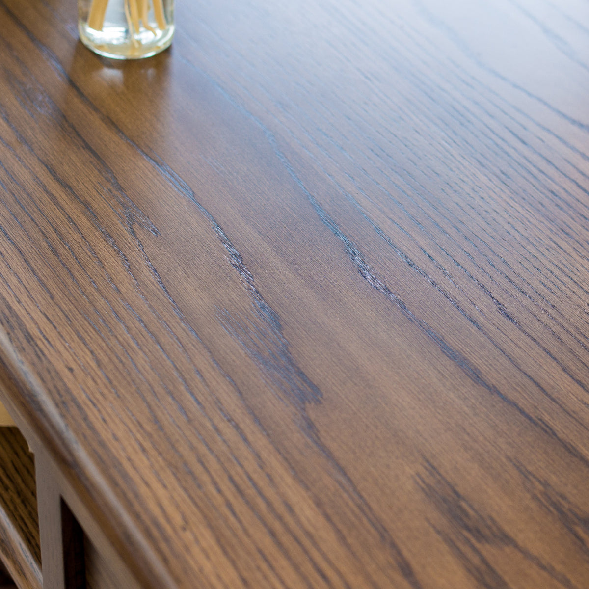 Close-up of a wooden surface with a glass object on it