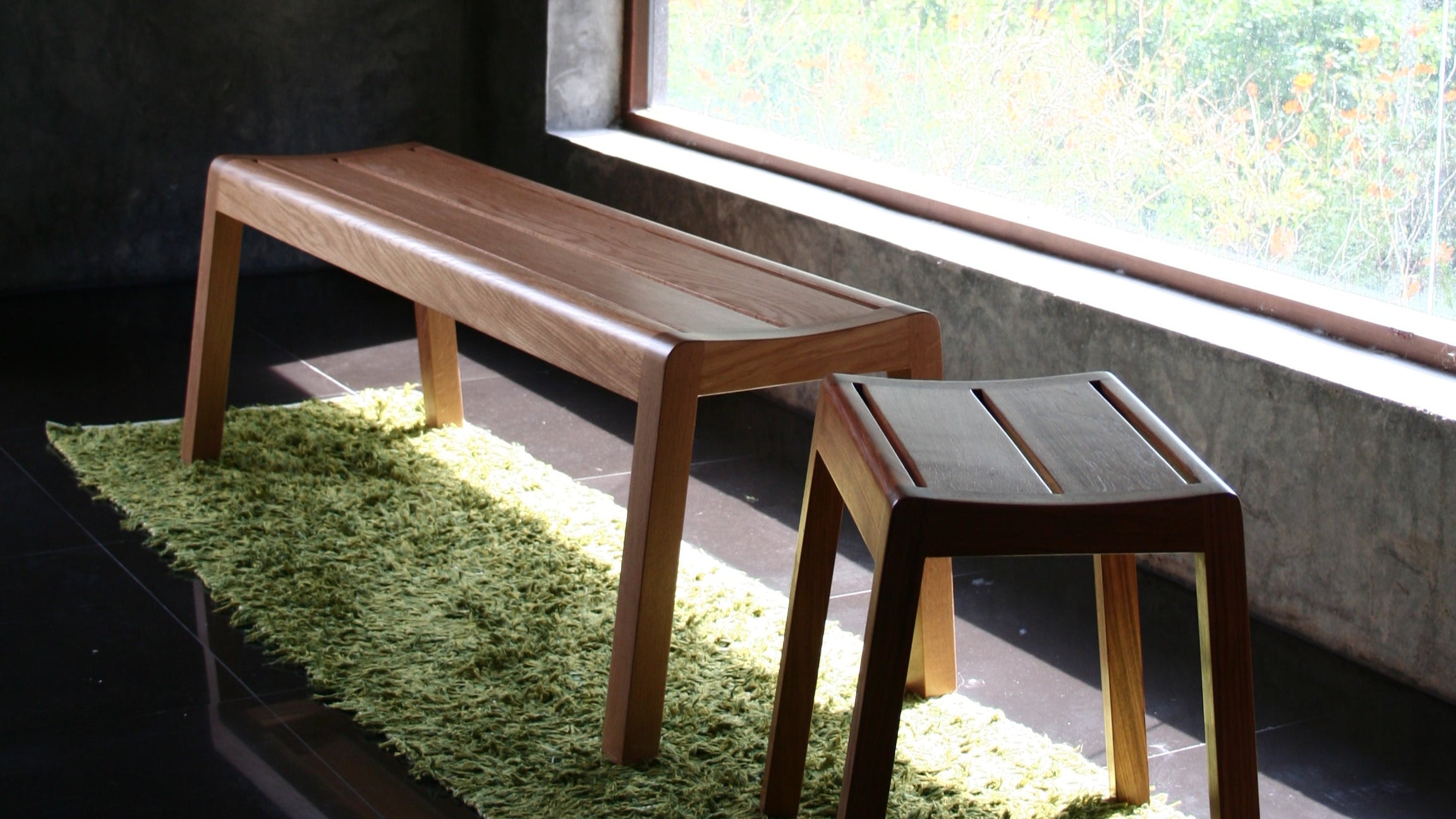 Solid wood bench and solid wood stool  in front of a windows
