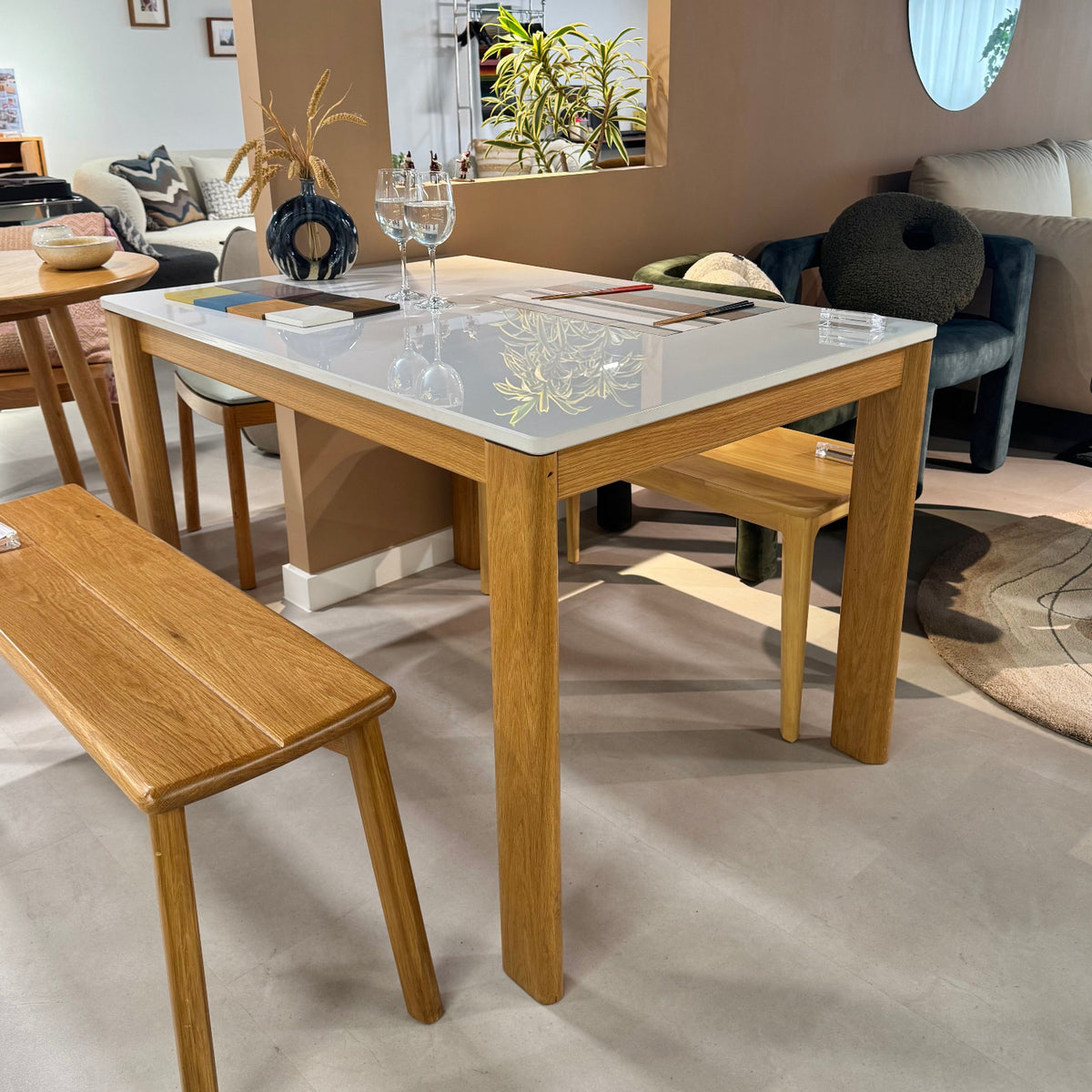 Dining area with wooden table and chairs in a modern interior setting.