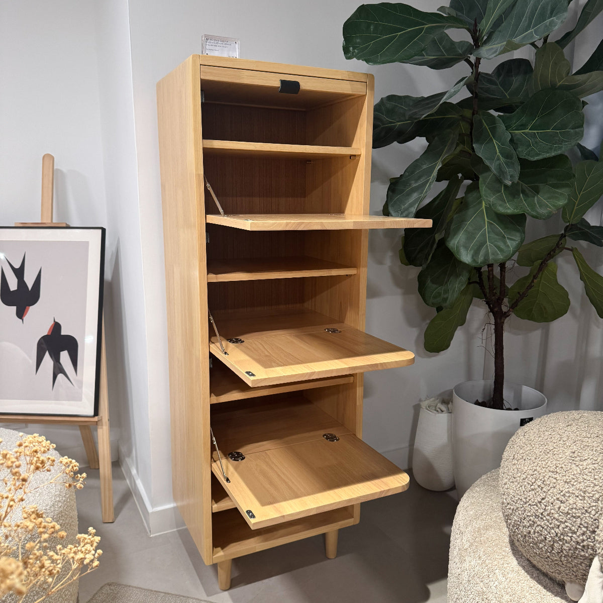 Wooden bookshelf with adjustable shelves in a living room setting.