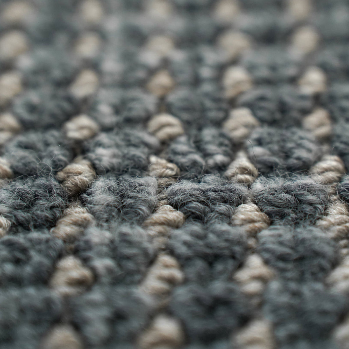 Close-up of a textured gray and beige carpet