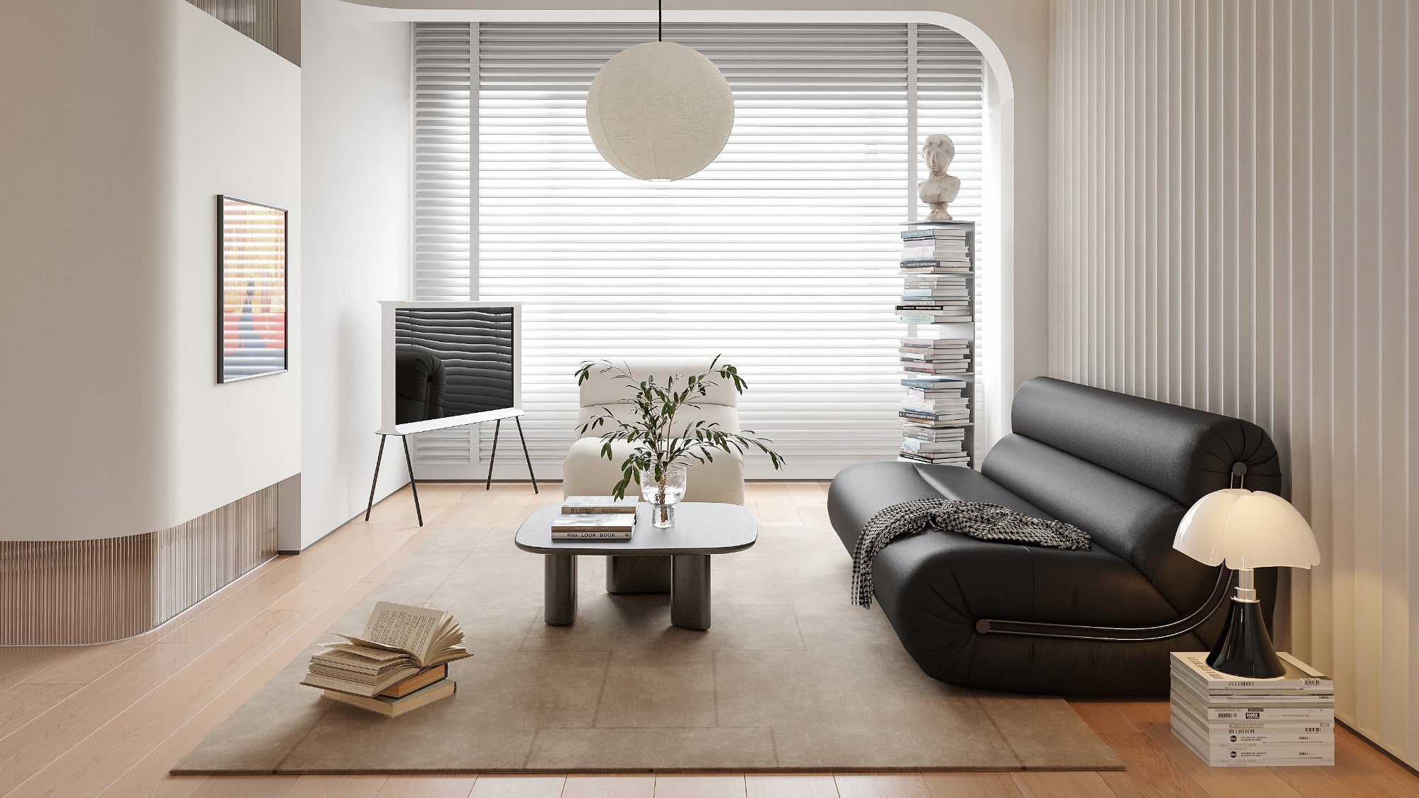 Modern living room with black sofa, coffee table, and decorative items.