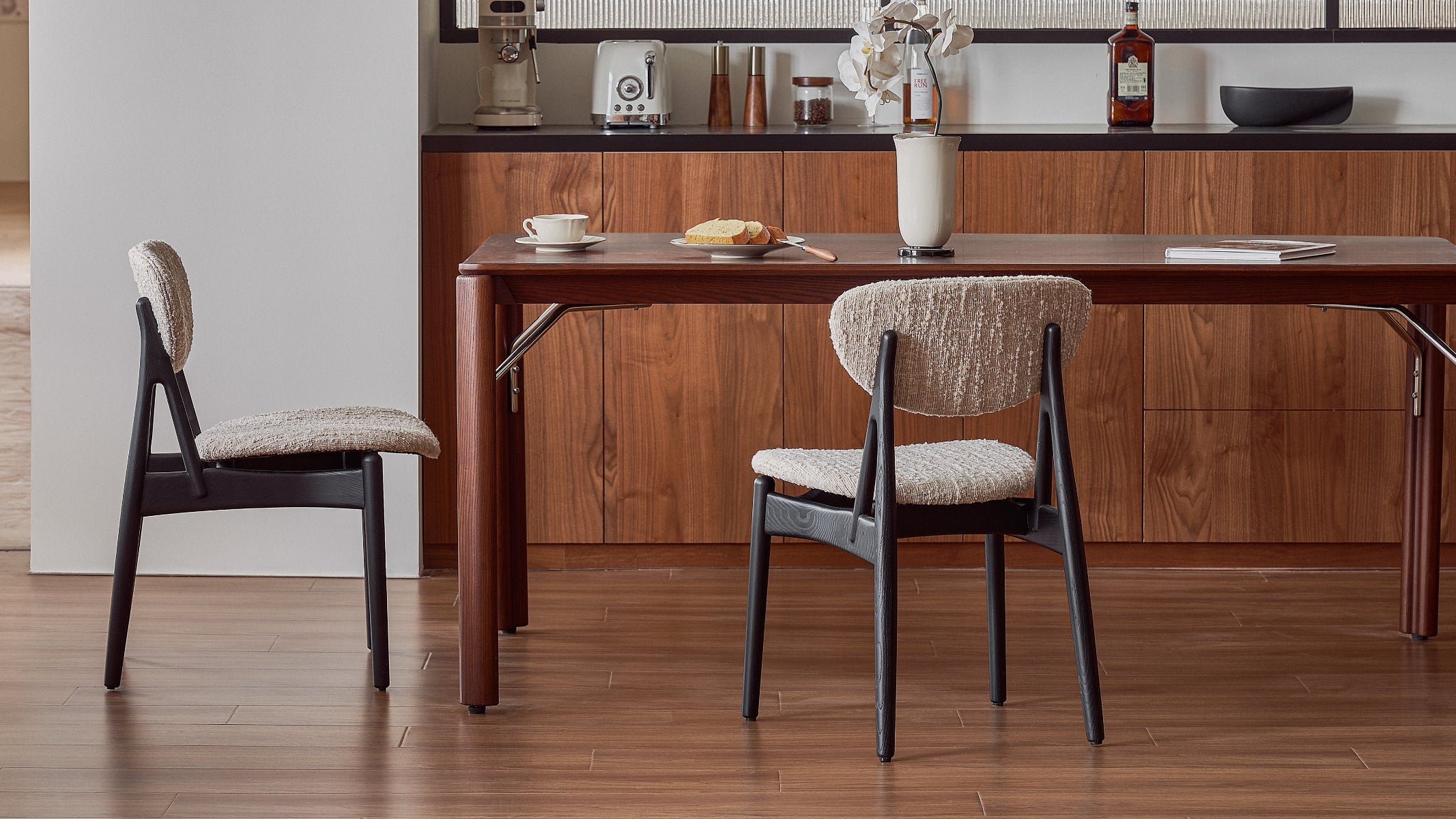 Dining area with wooden table and chairs in a modern kitchen.
