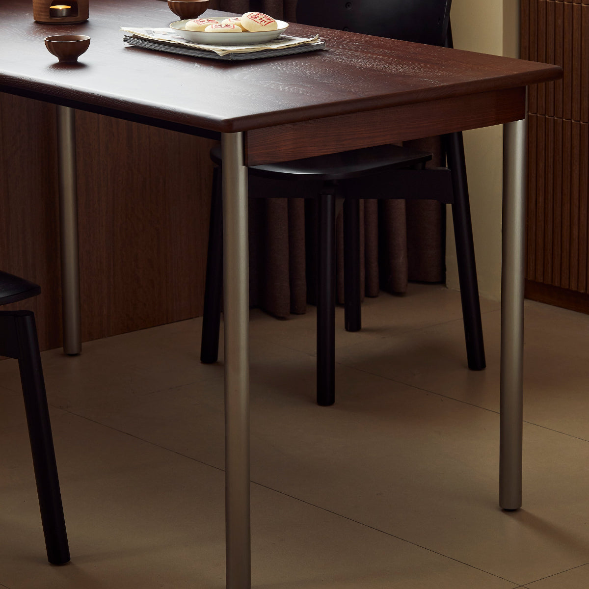 Dining table with chairs in a room with curtains and tiled floor
