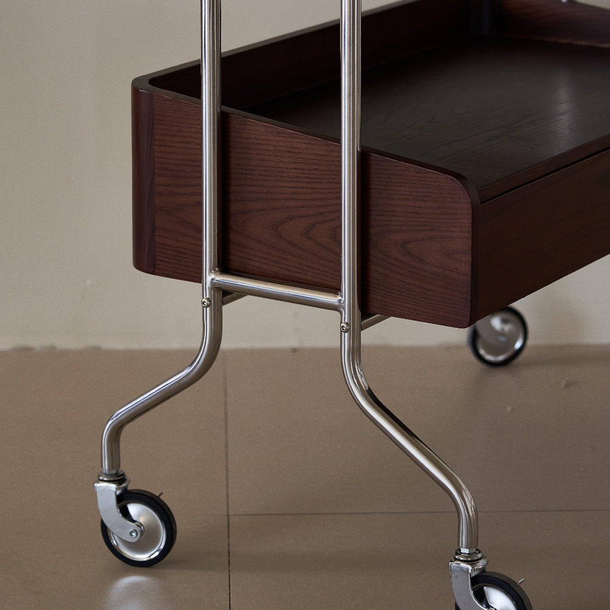 Wooden trolley with wheels on a reflective surface