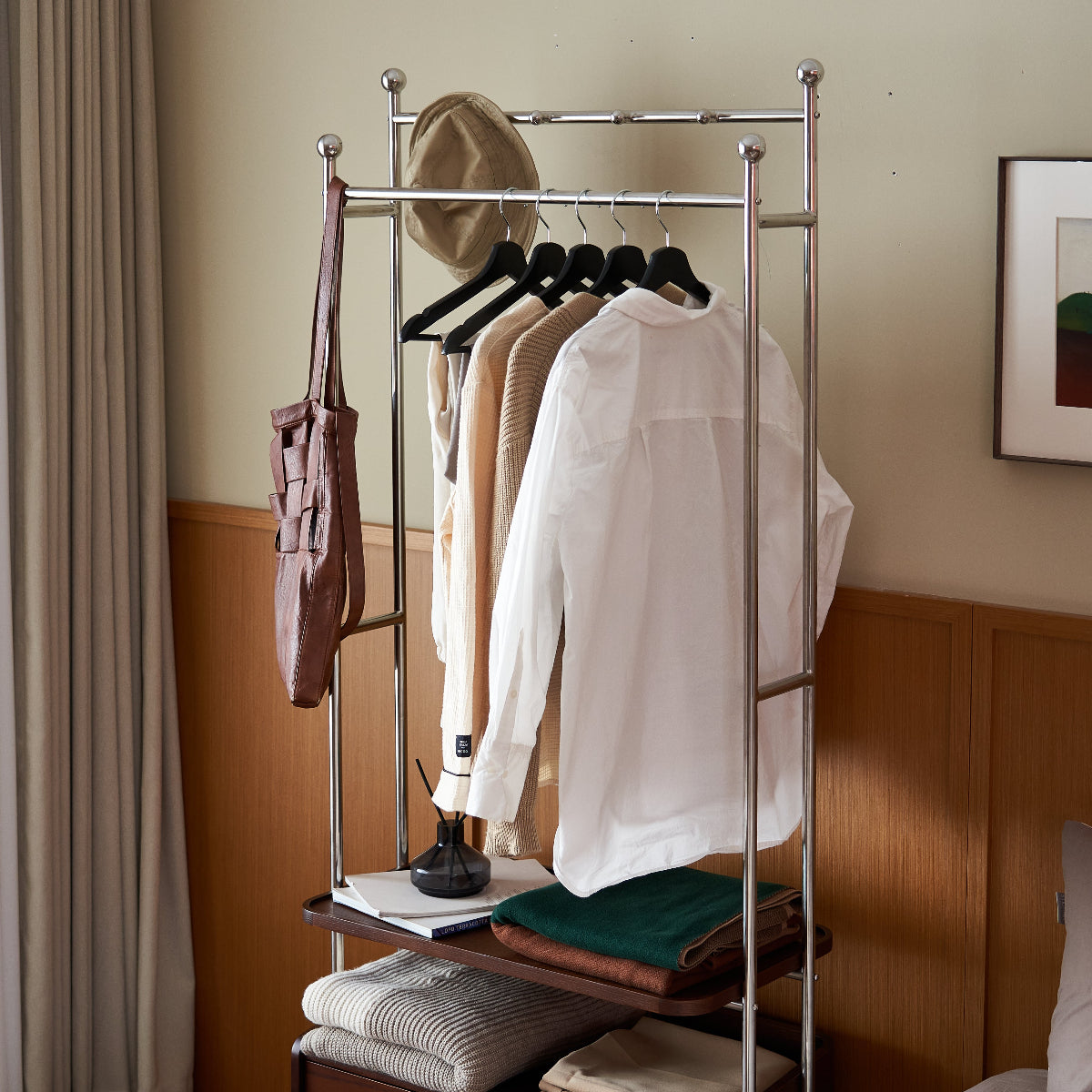 Clothing rack with clothes in a bedroom setting