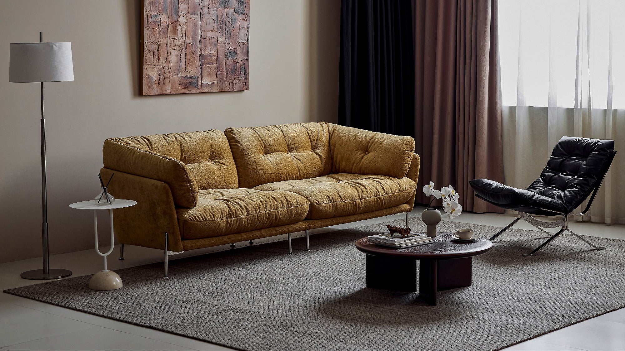 Modern living room with a brown sofa, black chair, and decorative elements.
