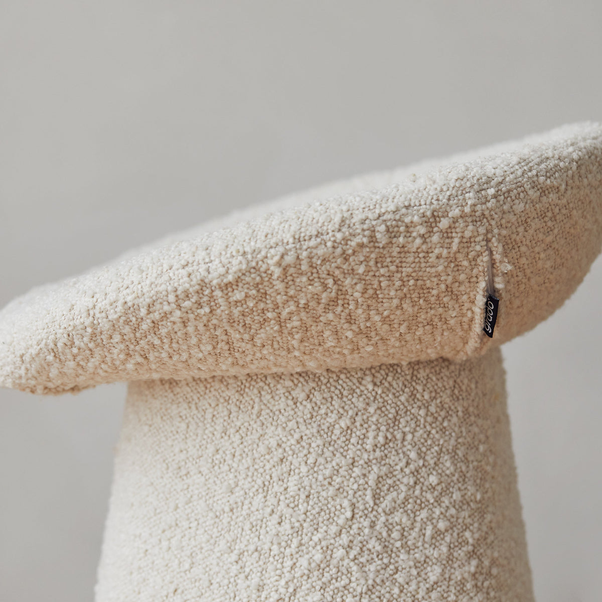 Textured stool with a light color on a plain background