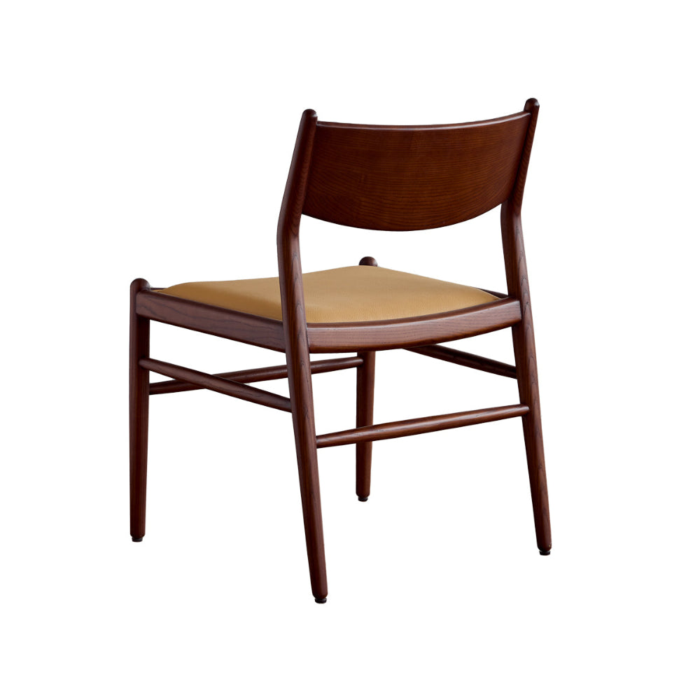 Wooden chair with beige cushion on a white background