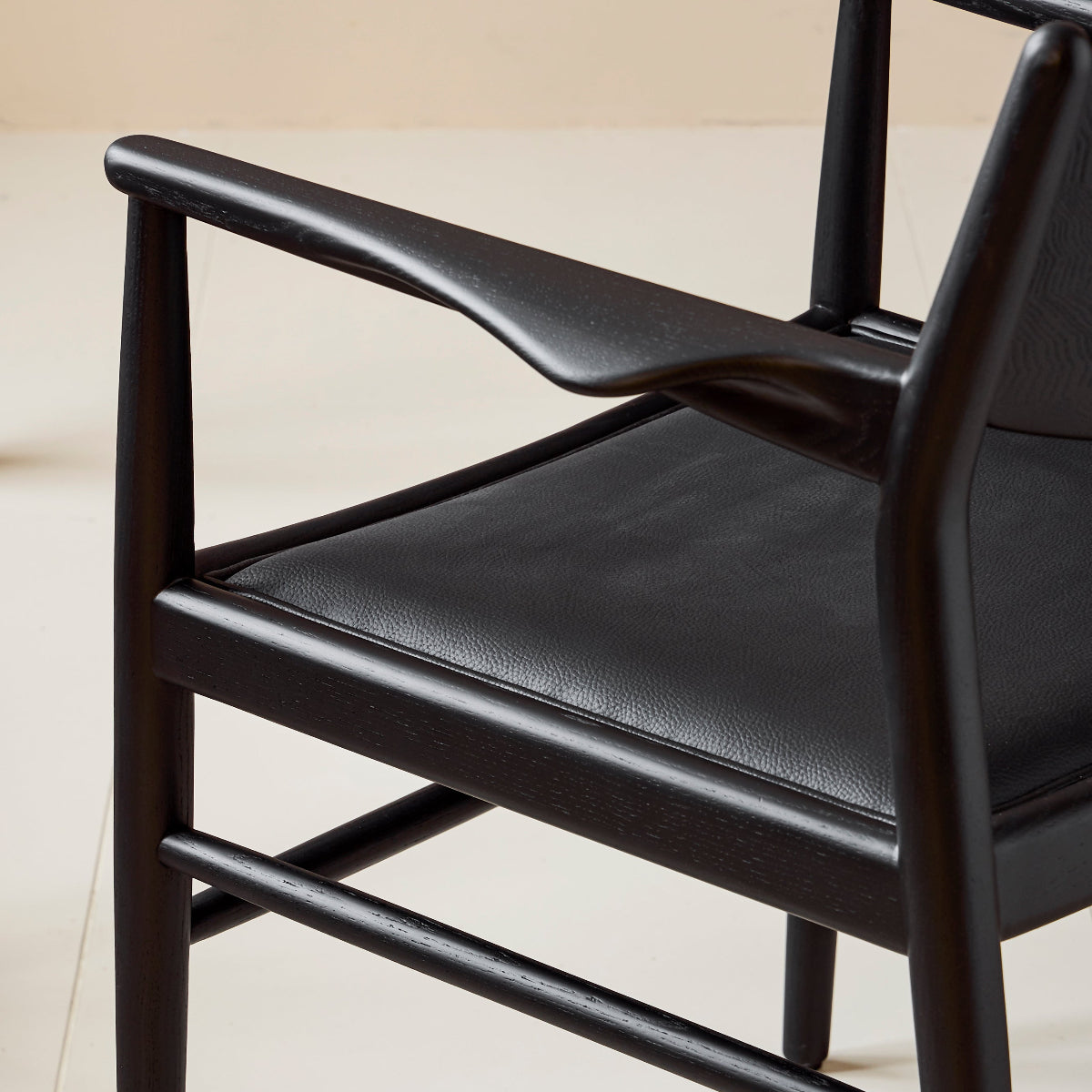 Black chair with leather seat on a light background