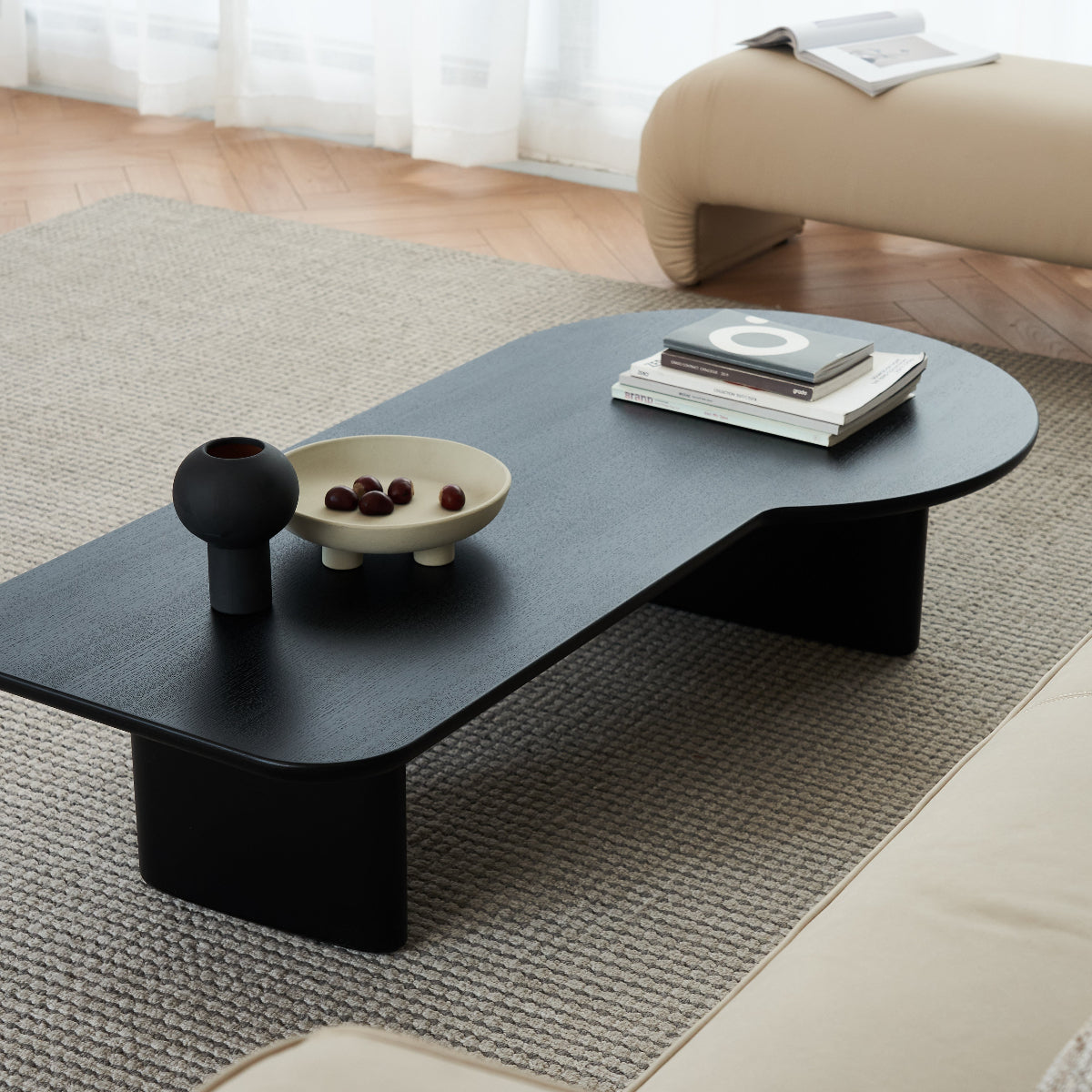 Modern black coffee table with decorative items in a living room setting