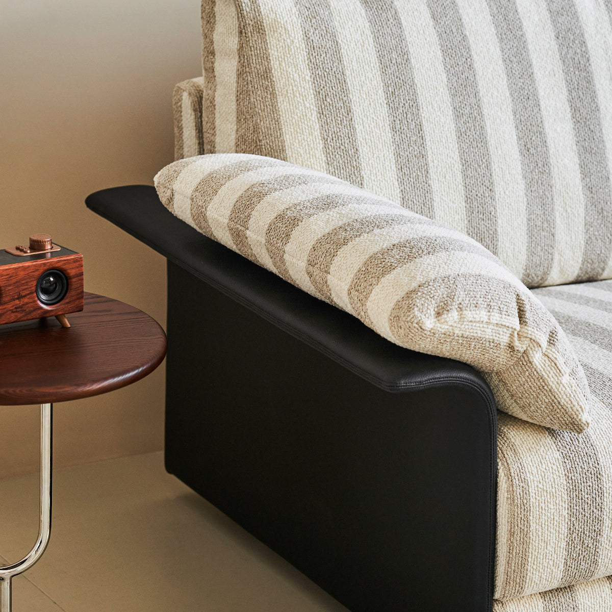 Striped sofa with a wooden side table in a living room setting