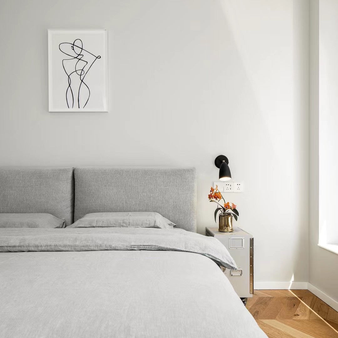 Modern bedroom with gray bed and abstract art on the wall