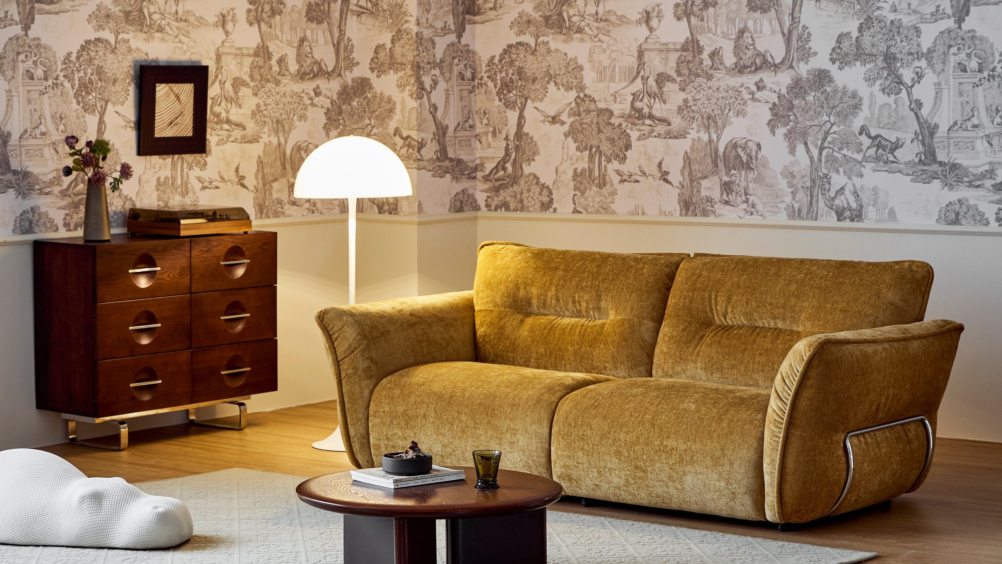 Living room with a brown sofa, wooden coffee table, and decorative items.
