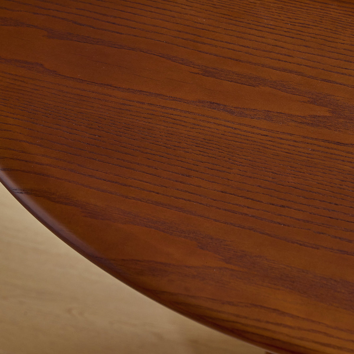 Close-up of a wooden table surface with a book on top.