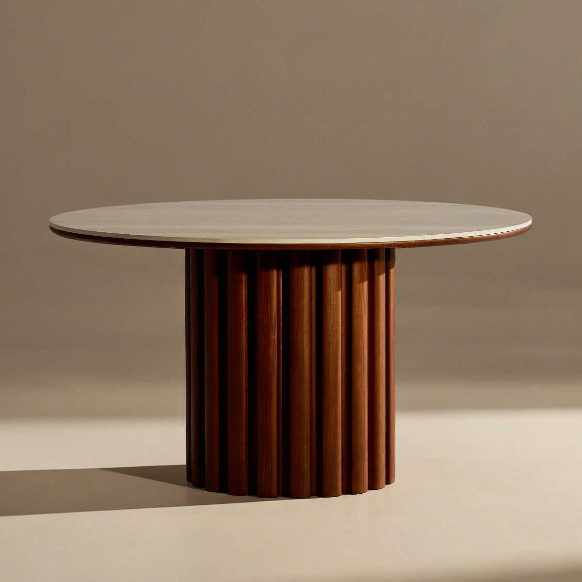 Round table with a textured cylindrical base on a beige background