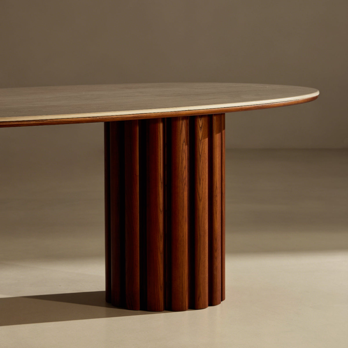 Round wooden table with a ribbed cylindrical base on a plain background