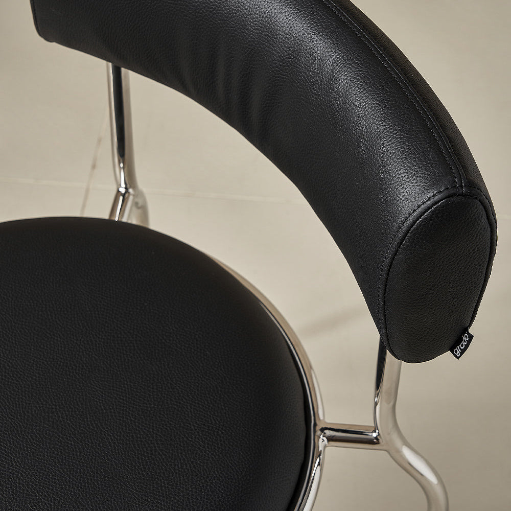 Black leather chair with chrome frame on a neutral background
