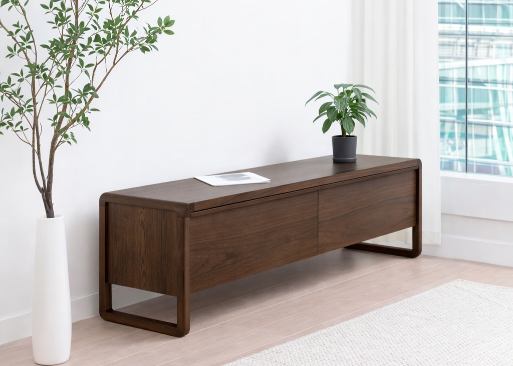 Wooden coffee table in a modern living room with plants and a rug.