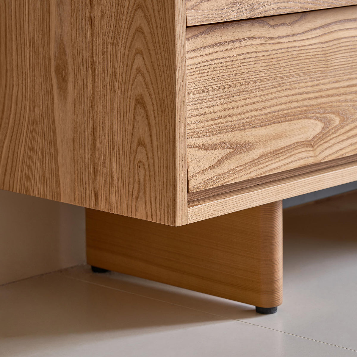Wooden drawer unit with a focus on the base and drawers.