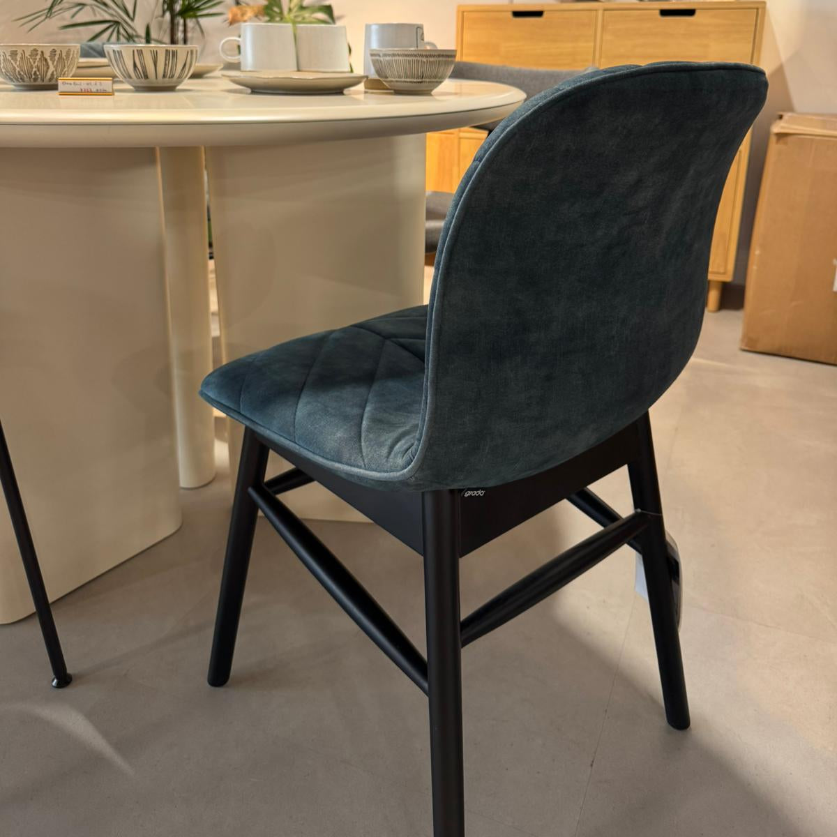 Blue chair in a dining room setting with a table and decor.